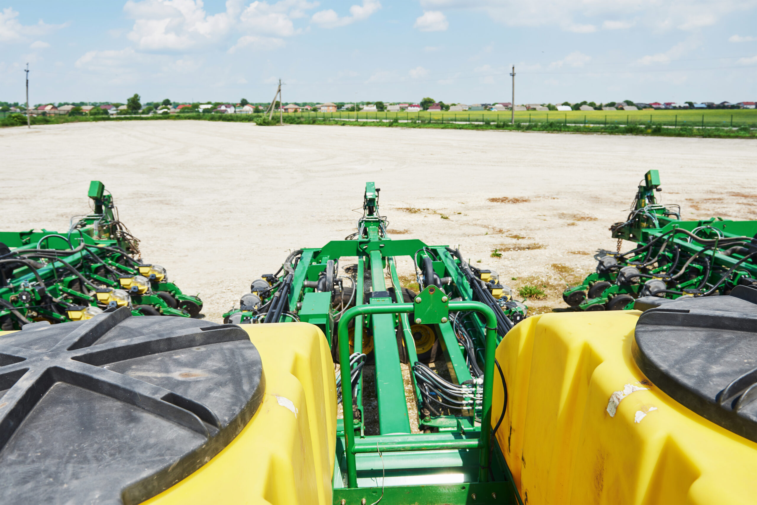 close up of seeder attached to tractor in field. agricultural machinery for spring works sowing